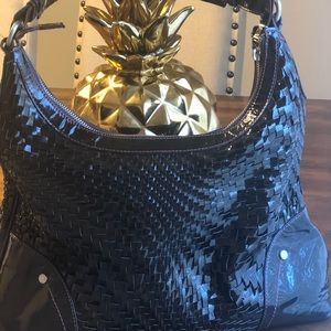 Beautiful brown leather purse with adjustable shoulder strap and zipper pocket.